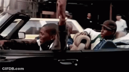 A Group Of Men Are Riding In A Convertible Car And Giving Each Other A High Five . GIF