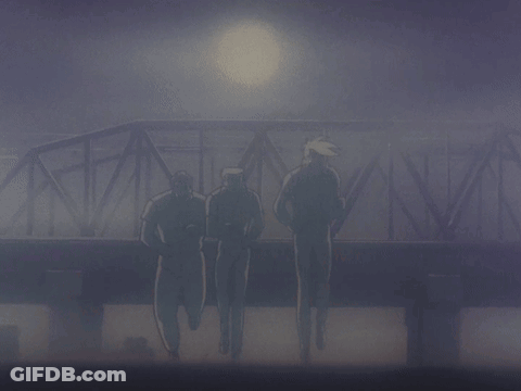 A Group Of Men Are Running Across A Bridge In The Dark GIF
