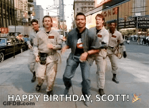 A Group Of Men Are Running Down A Street With The Words Happy Birthday Scott Written Below Them GIF