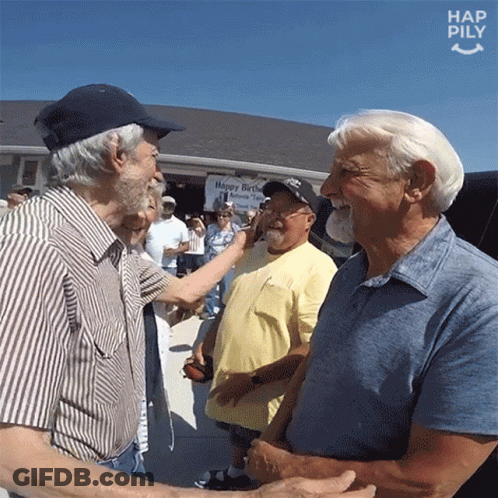 A Group Of Men Are Shaking Hands In Front Of A Sign That Says Happy Birthday GIF