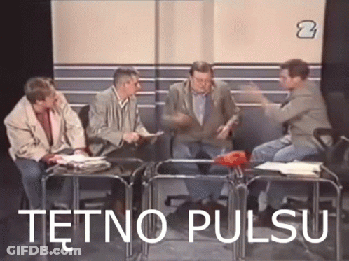 A Group Of Men Are Sitting Around A Table With The Words Tetno Pulsu Written On The Screen . GIF