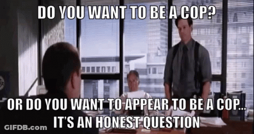 A Group Of Men Are Sitting At A Table And One Of Them Is Asking If They Want To Be A Cop GIF