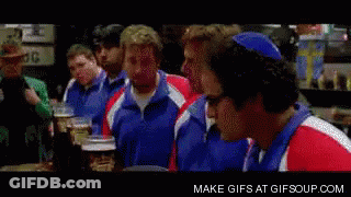 A Group Of Men Are Sitting At A Table And One Of Them Is Making A Surprised Face GIF