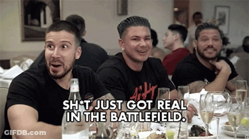 A Group Of Men Are Sitting At A Table With A Caption That Says " Shit Just Got Real In The Battlefield " GIF