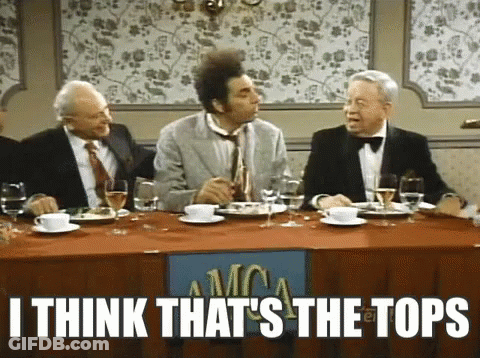 A Group Of Men Are Sitting At A Table With A Sign That Says I Think That 'S The Tops On It . GIF