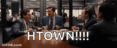 A Group Of Men Are Sitting At A Table With The Words Htown Written On The Table GIF