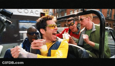 A Group Of Men Are Sitting In A Car In Front Of A Coach Building GIF