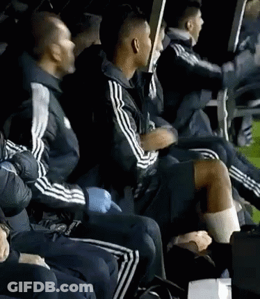 A Group Of Men Are Sitting In A Row Wearing Adidas Jackets GIF