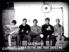 A Group Of Men Are Sitting In Chairs With A Guitar And A Newspaper . GIF