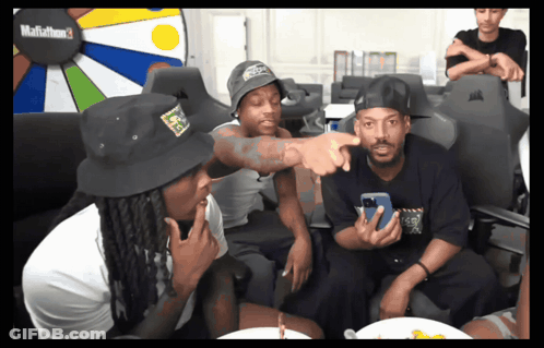 A Group Of Men Are Sitting In Front Of A Mafiathon 3 Display GIF