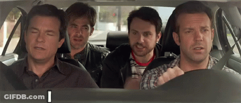 A Group Of Men Are Sitting In The Back Seat Of A Car Looking At Something . GIF