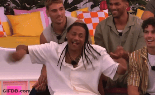 A Group Of Men Are Sitting On A Couch Laughing And Having Fun . GIF