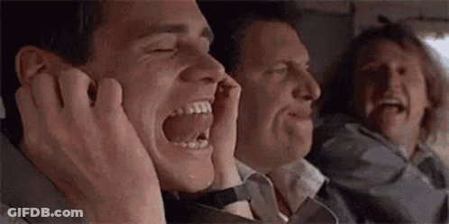 A Group Of Men Are Sitting On A Plane Laughing And Covering Their Ears With Their Hands . GIF