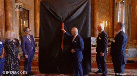 A Group Of Men Are Standing Around A Large Black Cloth That Says Ap GIF