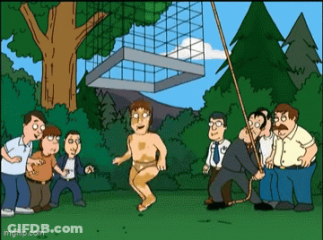 A Group Of Men Are Standing Around A Man In A Bathing Suit . GIF