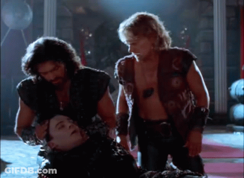 Men Standing Around Laying Man GIF