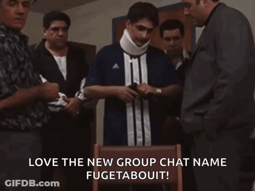 A Group Of Men Are Standing Around A Man Wearing A Neck Brace And A Shirt That Says Adidas GIF