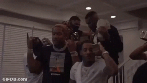 A Group Of Men Are Standing Around Each Other Holding Money . GIF