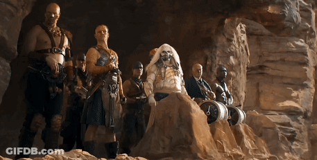 A Group Of Men Are Standing In A Cave With One Of Them Wearing A Wig GIF