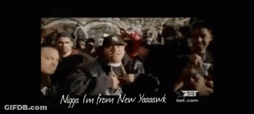 A Group Of Men Are Standing In A Crowd And One Of Them Is Wearing A Hat That Says Ny On It . GIF
