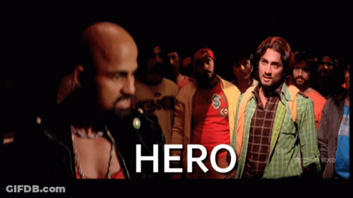 A Group Of Men Are Standing In A Crowd And The Word Hero Is On The Screen GIF