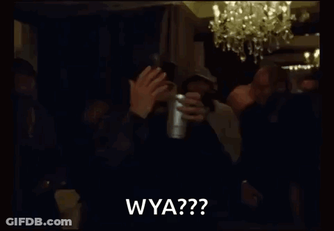 A Group Of Men Are Standing In A Dark Room Holding A Cup And Clapping . GIF
