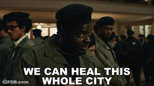A Group Of Men Are Standing In A Line With The Words We Can Heal This Whole City On The Bottom GIF