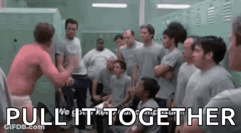 A Group Of Men Are Standing In A Locker Room And One Of Them Is Wrestling Another Man . GIF