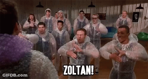A Group Of Men Are Standing In A Room Wearing Plastic Bubble Wrap And Dancing . GIF