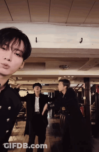 A Group Of Men Are Standing In A Room With A Ceiling That Has A Hook On It GIF