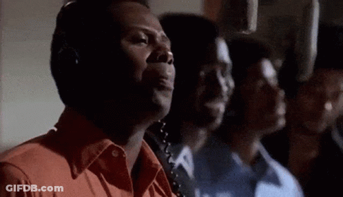 A Group Of Men Are Standing In A Room With Headphones On . GIF