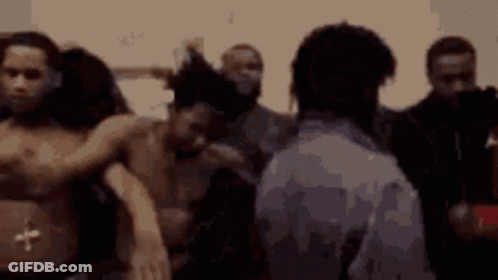 A Group Of Men Are Standing In A Room Without Shirts On GIF