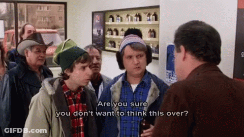 A Group Of Men Are Standing In A Store Talking To Each Other And One Of Them Is Holding A Bottle Of Beer . GIF
