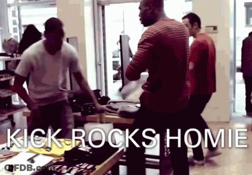 A Group Of Men Are Standing In A Store With The Words Kick Rocks Homie GIF