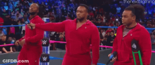 A Group Of Men Are Standing In A Wrestling Ring . GIF