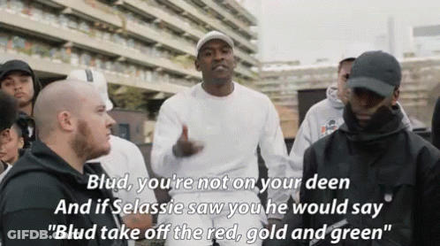 A Group Of Men Are Standing In Front Of A Building And One Of Them Says Blud You 'Re Not On Your Deen . GIF