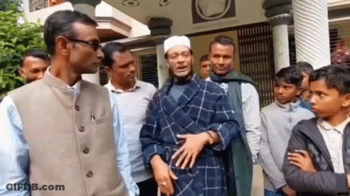 A Group Of Men Are Standing In Front Of A Building . GIF