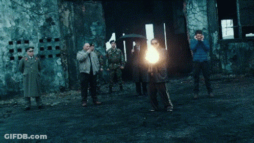 A Group Of Men Are Standing In Front Of A Building With Soldiers GIF