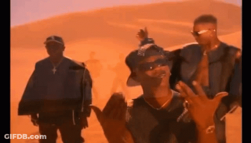 A Group Of Men Are Standing In Front Of A Desert . GIF