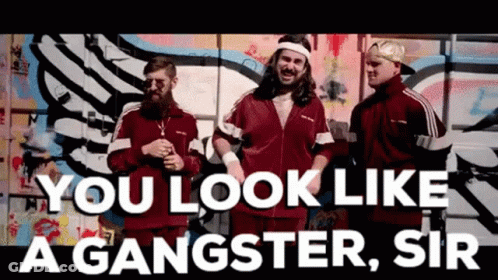 A Group Of Men Are Standing In Front Of A Graffiti Wall With The Words You Look Like A Gangster Sir GIF
