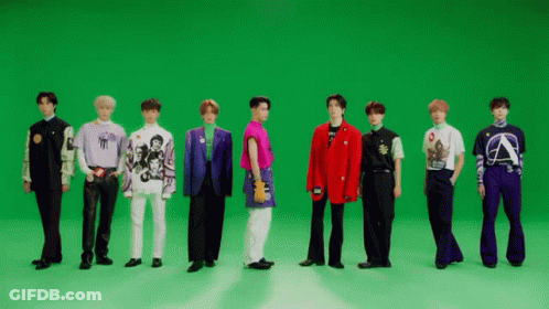 A Group Of Men Are Standing In Front Of A Green Screen . GIF