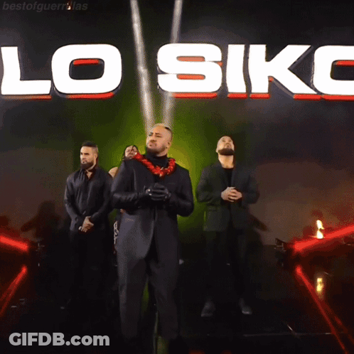 A Group Of Men Are Standing In Front Of A Large Sign That Says Lo Siko GIF