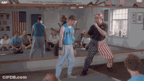 A Group Of Men Are Standing In Front Of A Mirror With A Sign That Says I Shall Be A Champion Of GIF