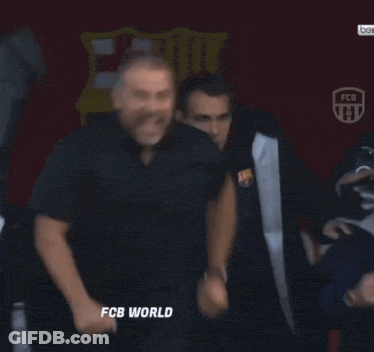 A Group Of Men Are Standing In Front Of A Sign That Says " Fcb World " GIF