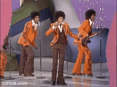 A Group Of Men Are Standing In Front Of Microphones On A Stage . GIF