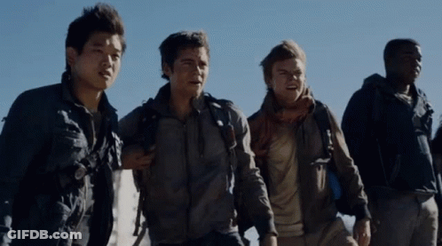 A Group Of Men Are Standing Next To Each Other And One Has A Backpack On His Back GIF