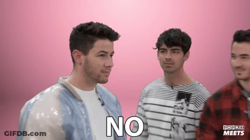 A Group Of Men Are Standing Next To Each Other And One Of Them Has The Word No On His Chest GIF