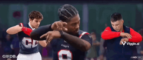 A Group Of Men Are Standing Next To Each Other And One Of Them Is Pointing At The Camera GIF