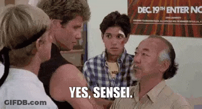 A Group Of Men Are Standing Next To Each Other And One Of Them Is Talking To Another Man . GIF