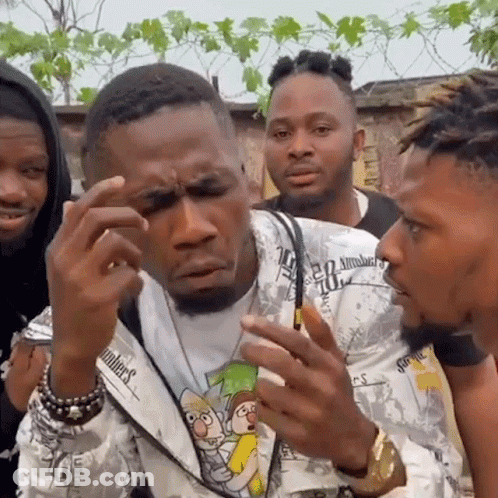 A Group Of Men Are Standing Next To Each Other And One Of Them Is Wearing A Shirt That Says Numbers . GIF